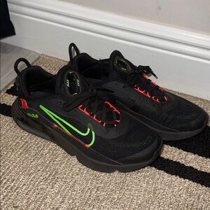 Nike Black Sneakers with Green and Red Accents